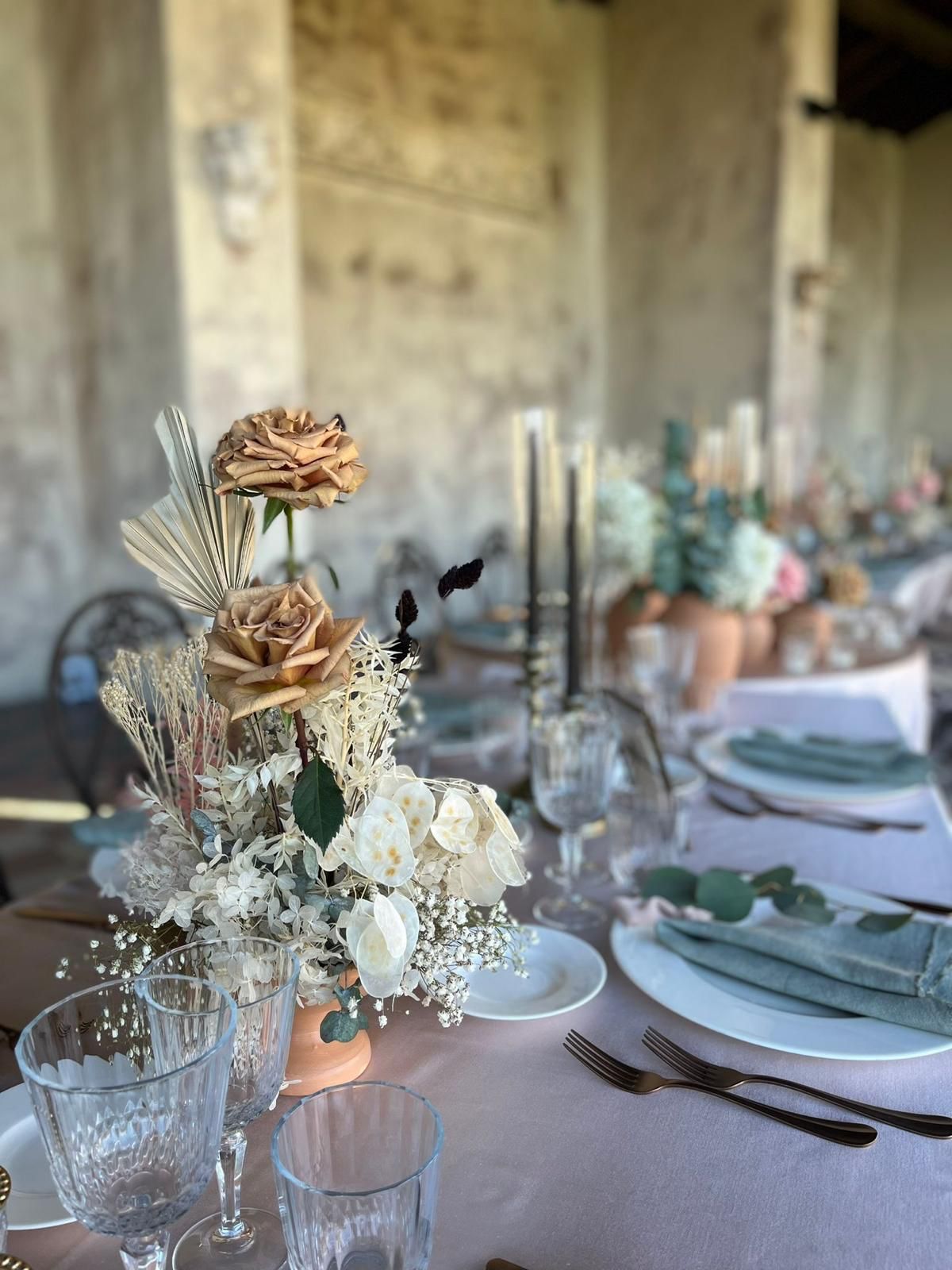 Soft-toned floral centerpiece on an elegant event table