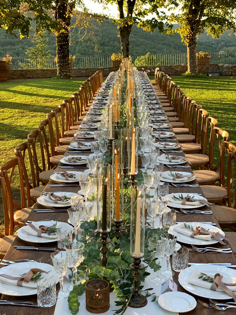 Romantic event table with layered flowers and candles