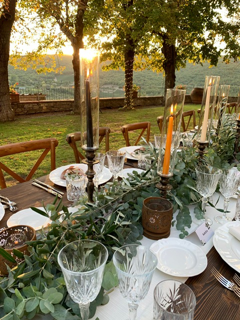 Tuscan celebration decor arranged with glassware and soft florals