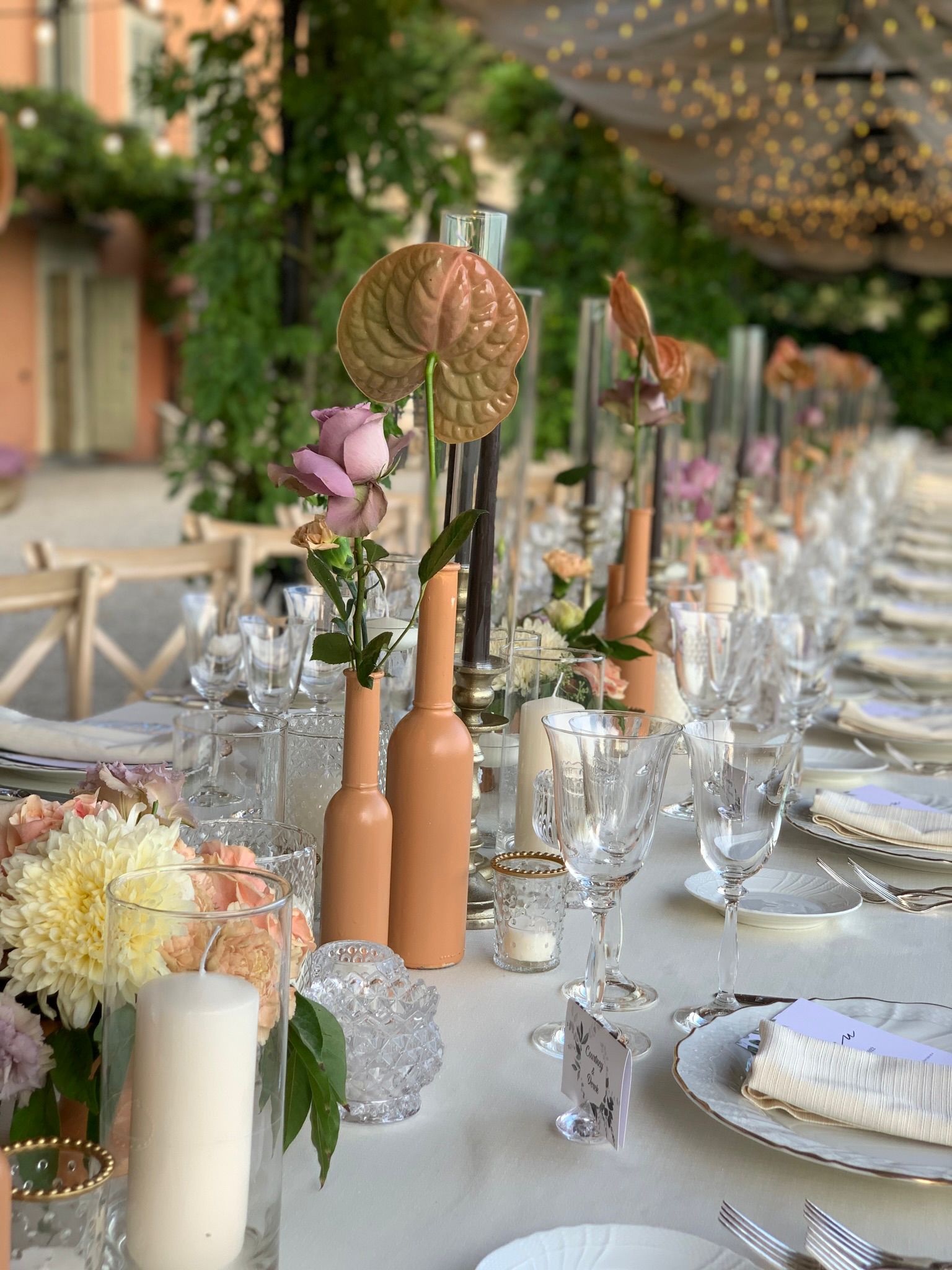 Decorative event scene with candles, flowers and curated table styling